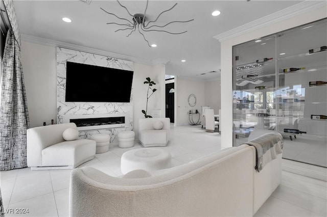 living room with a premium fireplace, an inviting chandelier, light tile patterned floors, and ornamental molding