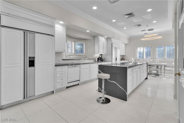 kitchen featuring dishwasher, a center island, white cabinetry, and a healthy amount of sunlight