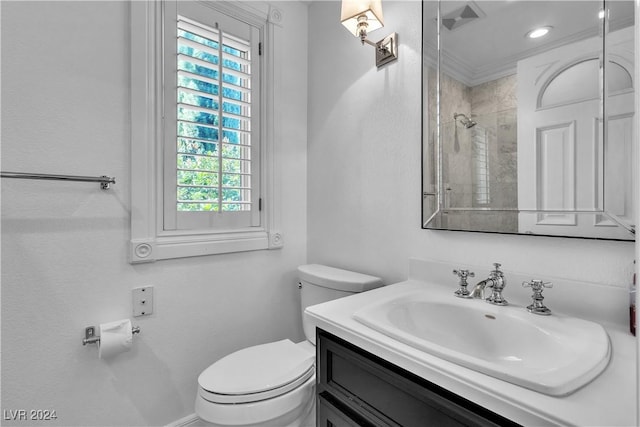 bathroom featuring vanity, a shower, toilet, and crown molding