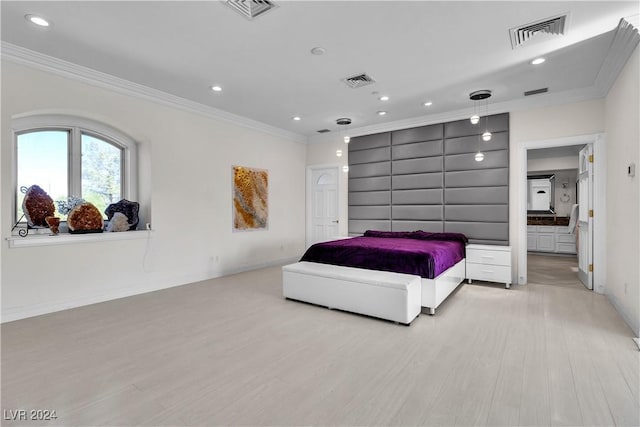 bedroom featuring crown molding and light wood-type flooring