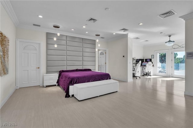 bedroom with ornamental molding and light hardwood / wood-style flooring