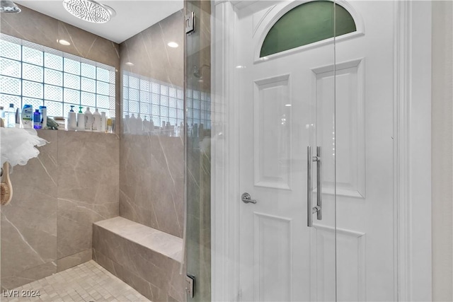 bathroom featuring a shower with door