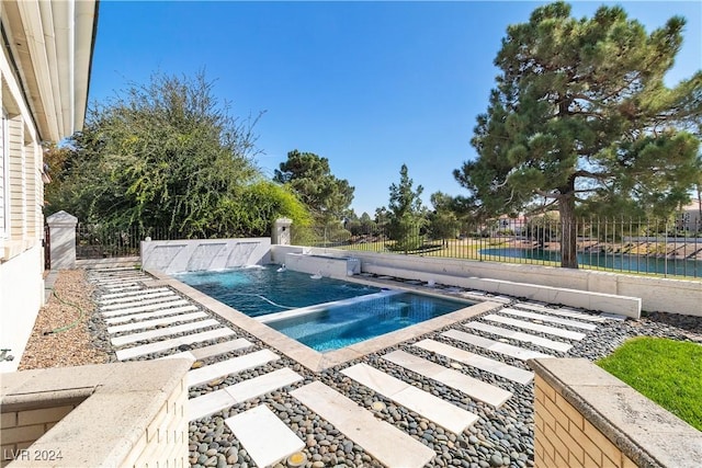 view of pool with an in ground hot tub and pool water feature