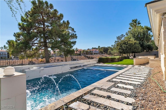 view of swimming pool with pool water feature