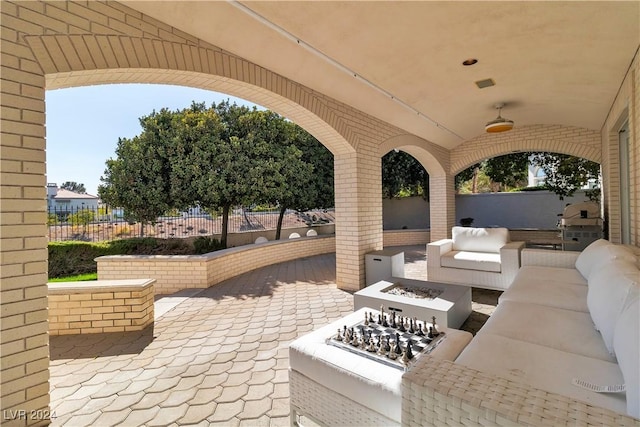 view of patio featuring an outdoor living space with a fire pit