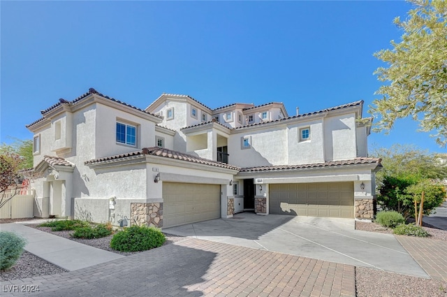 mediterranean / spanish home with a garage