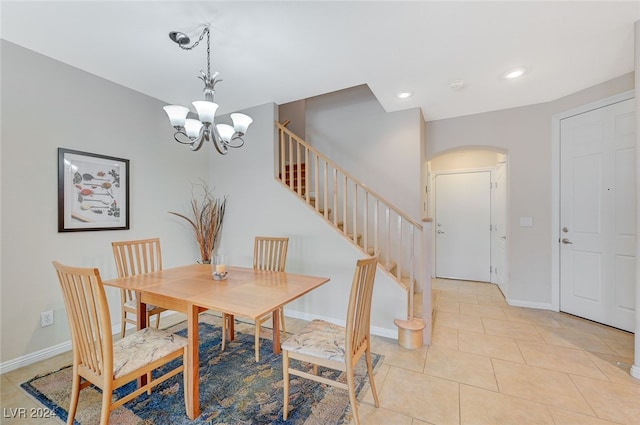 tiled dining space with a notable chandelier