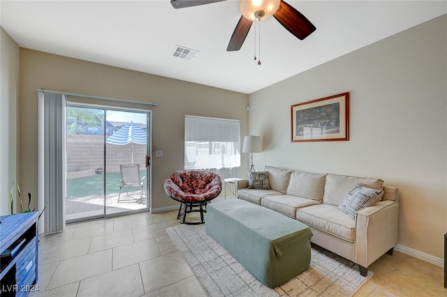 living room with ceiling fan and light tile patterned floors