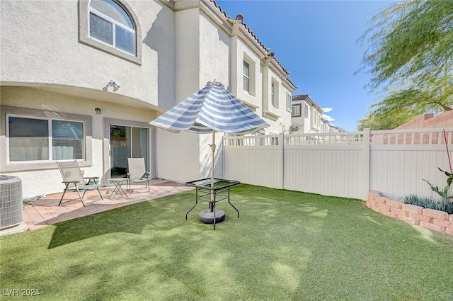 view of yard featuring central air condition unit and a patio