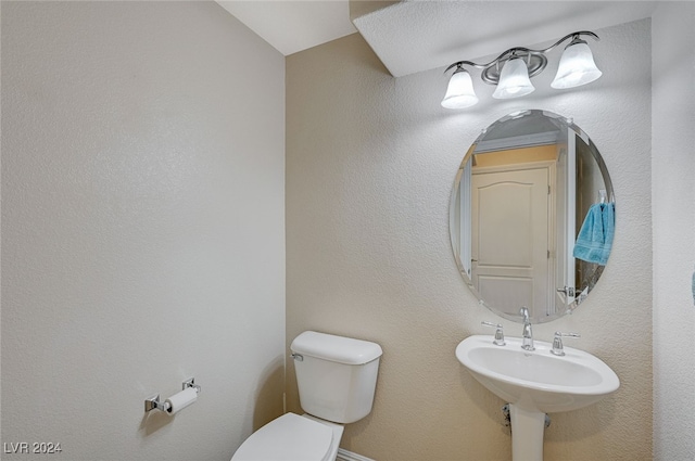 bathroom with toilet and sink