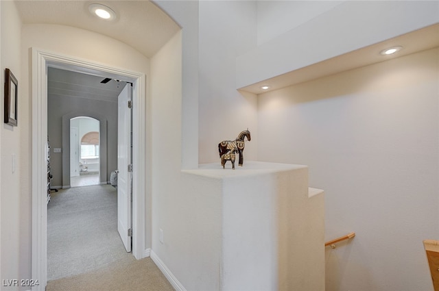 hallway with light colored carpet