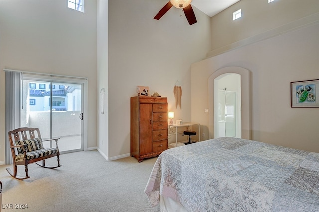 carpeted bedroom with ceiling fan, a towering ceiling, and access to exterior