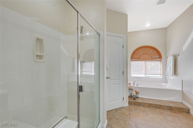 bathroom featuring shower with separate bathtub