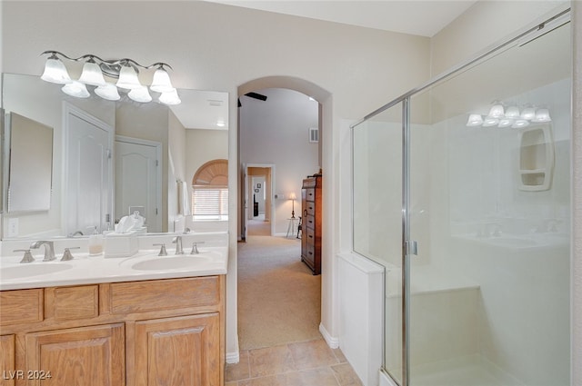 bathroom featuring vanity, a shower with shower door, and tile patterned flooring