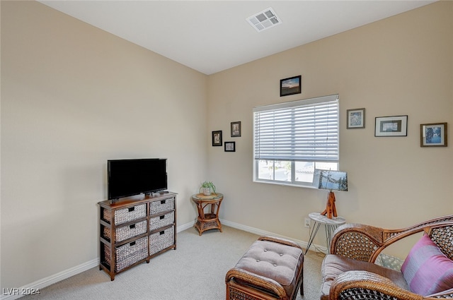 living area with light carpet