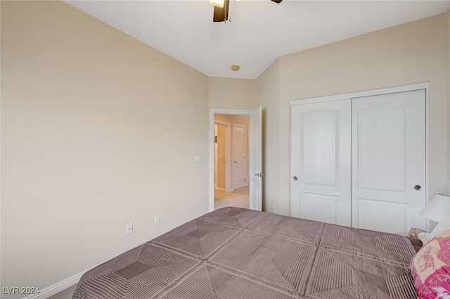 unfurnished bedroom with light carpet, a closet, and ceiling fan