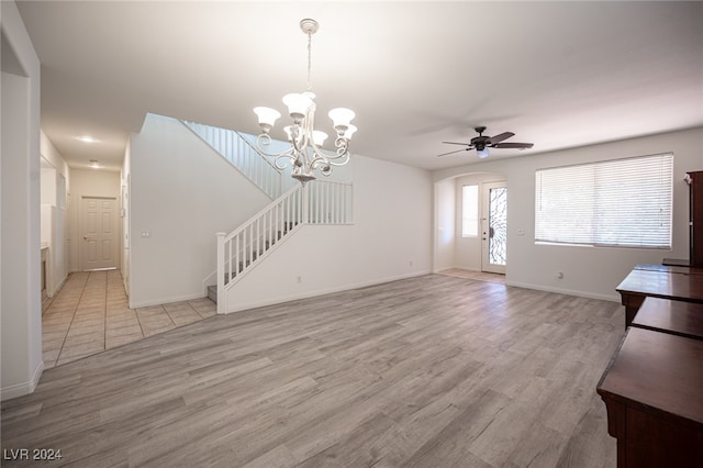 unfurnished living room with light hardwood / wood-style flooring and ceiling fan with notable chandelier