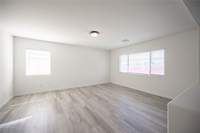 spare room featuring light hardwood / wood-style flooring