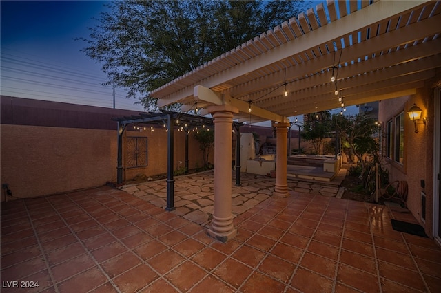 patio terrace at dusk featuring a pergola