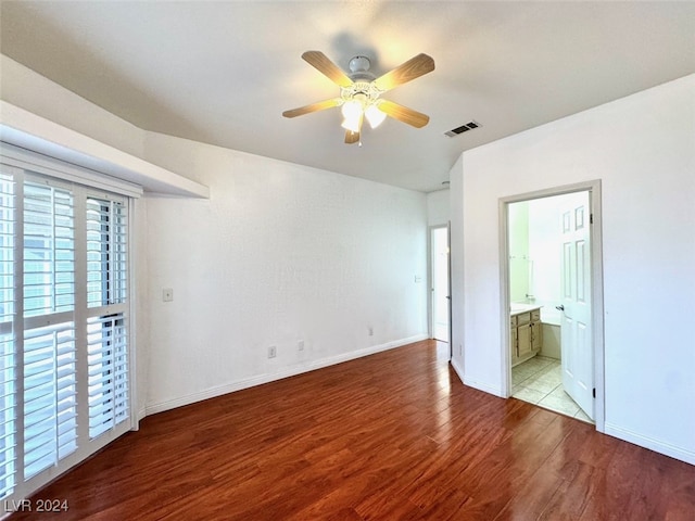 unfurnished bedroom with connected bathroom, ceiling fan, and light hardwood / wood-style flooring