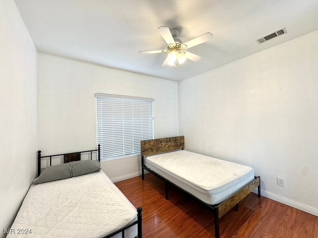 bedroom featuring dark wood-type flooring and ceiling fan