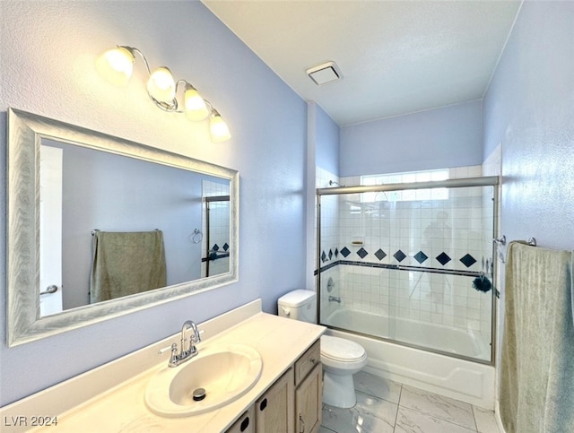 full bathroom featuring vanity, shower / bath combination with glass door, and toilet