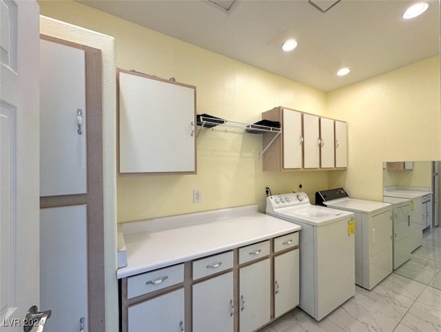 laundry room featuring cabinets and washer and dryer