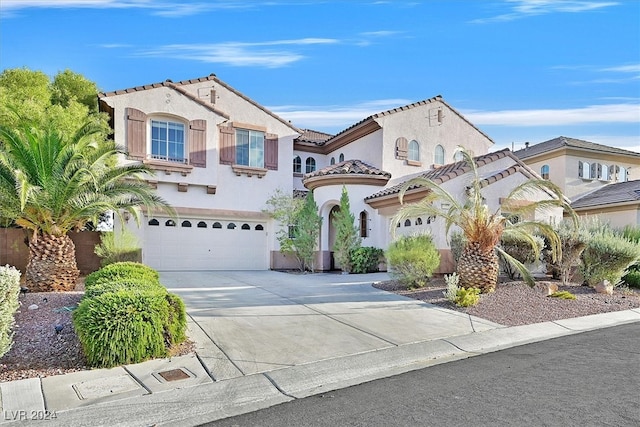 mediterranean / spanish-style home featuring a garage