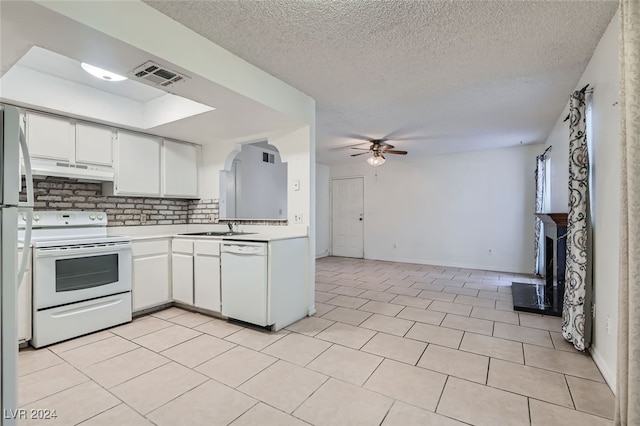 kitchen with tasteful backsplash, ceiling fan, white cabinetry, sink, and white appliances