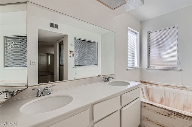 bathroom with vanity and a relaxing tiled tub