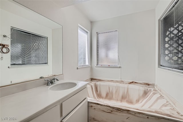 bathroom with vanity and a tub