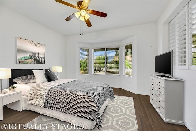 bedroom with ceiling fan and dark wood-type flooring