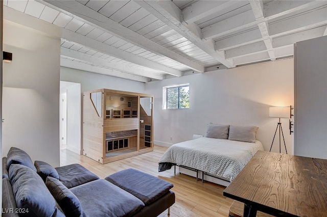 bedroom featuring hardwood / wood-style flooring and beamed ceiling