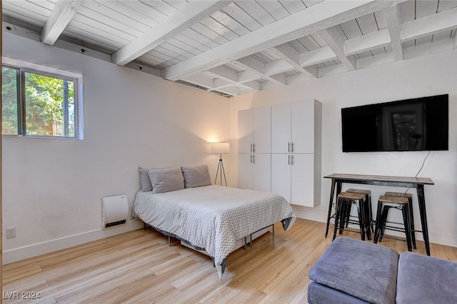 bedroom with light hardwood / wood-style flooring, beam ceiling, and wooden ceiling