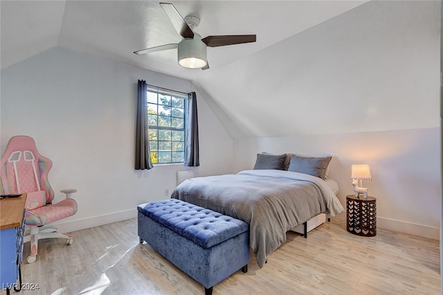 bedroom with ceiling fan, vaulted ceiling, and light wood-type flooring