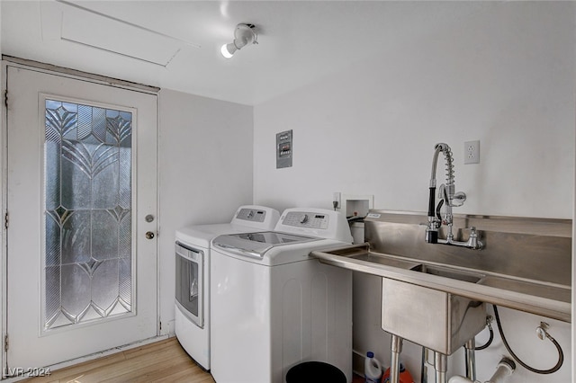 laundry area featuring light hardwood / wood-style flooring and washer and clothes dryer