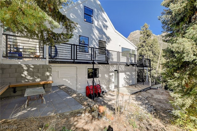 back of property featuring a patio area and a balcony