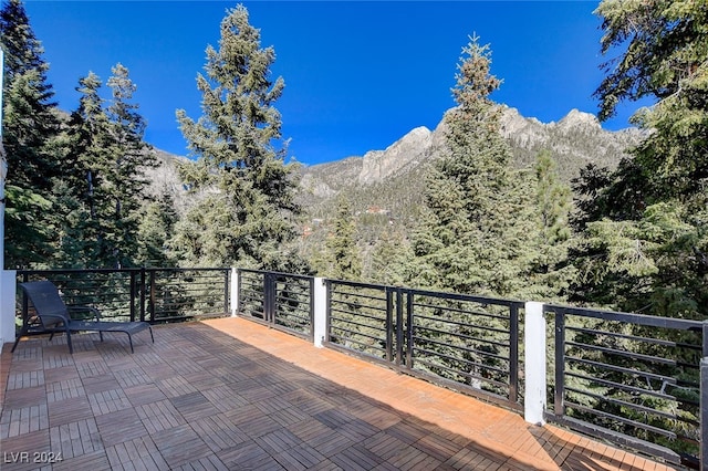 view of patio with a balcony and a mountain view