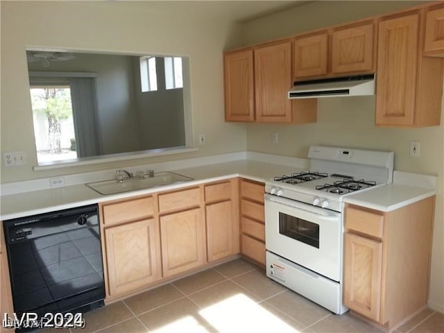 kitchen with white range with gas cooktop, black dishwasher, light brown cabinetry, light tile patterned flooring, and sink