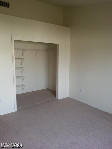 unfurnished bedroom with carpet floors and a closet