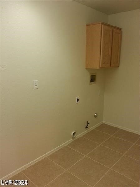 clothes washing area with cabinets, gas dryer hookup, hookup for a washing machine, electric dryer hookup, and tile patterned floors