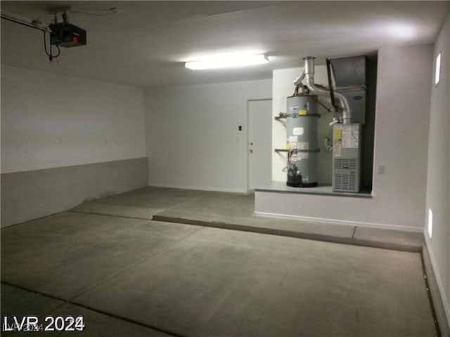 garage featuring a garage door opener, heating unit, and secured water heater