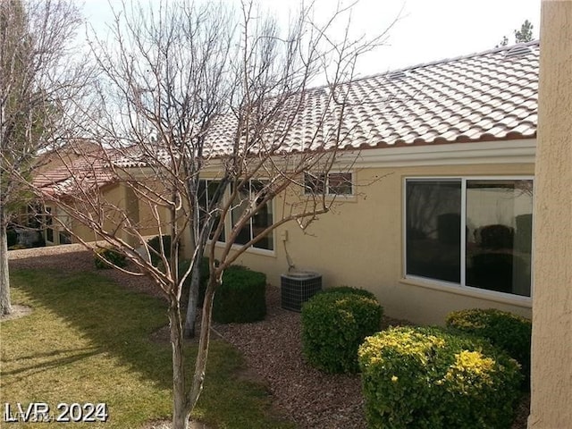 view of side of home featuring a lawn