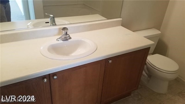 bathroom with vanity, toilet, and tile patterned flooring