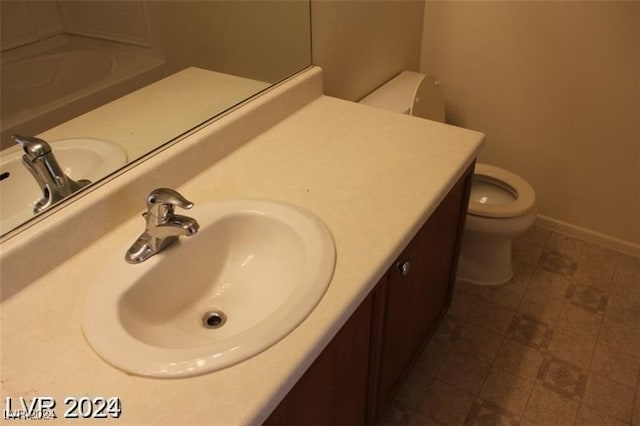 bathroom featuring vanity, toilet, and tile patterned floors