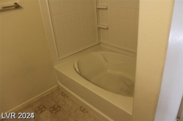 bathroom with tile patterned floors and a bathing tub