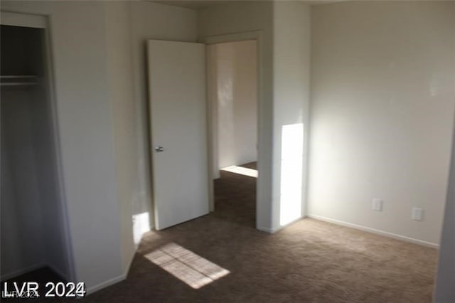 unfurnished bedroom with a closet and carpet floors