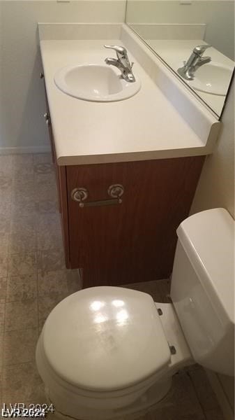 bathroom with vanity, toilet, and tile patterned flooring