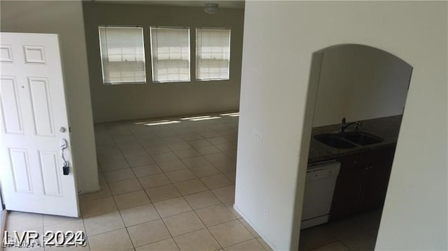 interior space with light tile patterned floors and sink