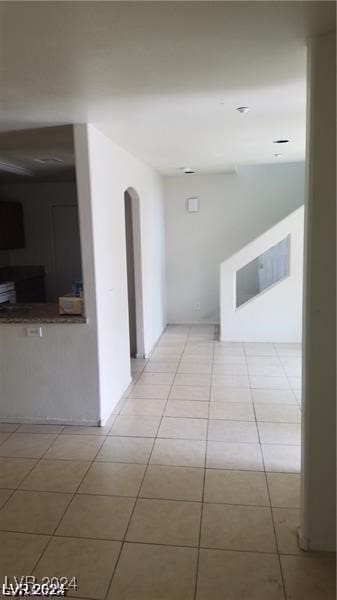 hallway featuring light tile patterned floors